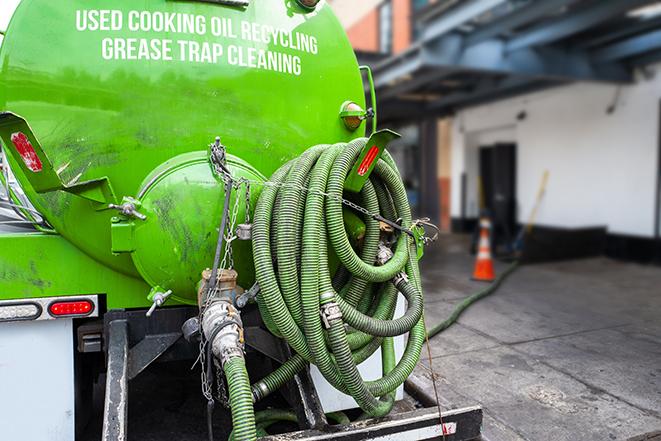 a service truck pumping grease from a restaurant's grease trap in Santa Fe Springs, CA